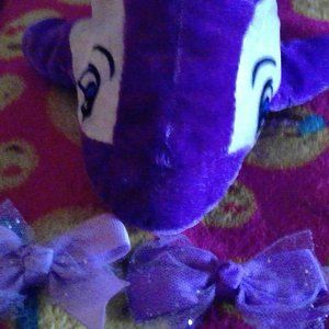 Plush dolphin,with 2 purple bows